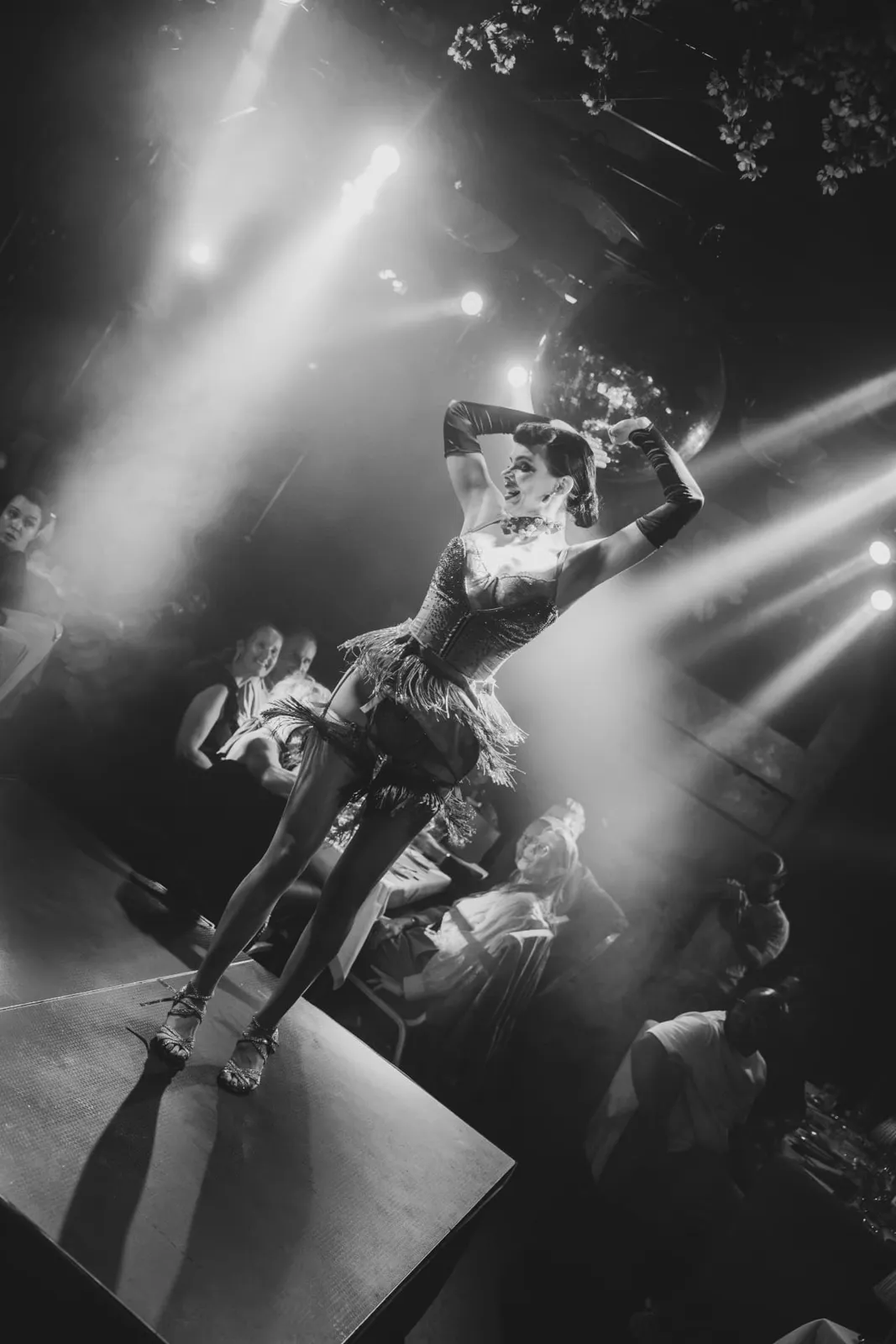Black and white photo of a dancer on stage during the Dinner Show