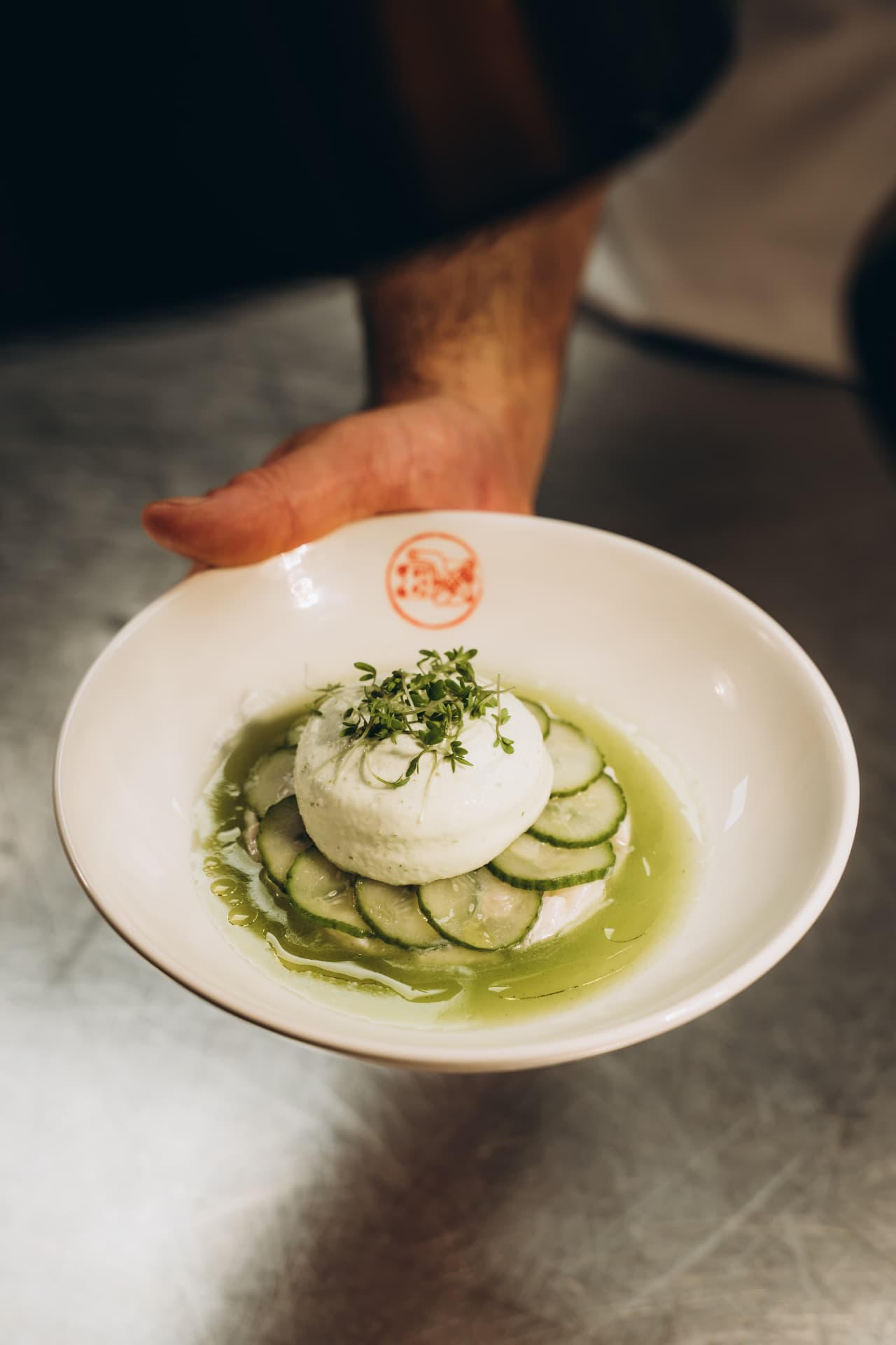 Burrata with cucumber in a green herb oil